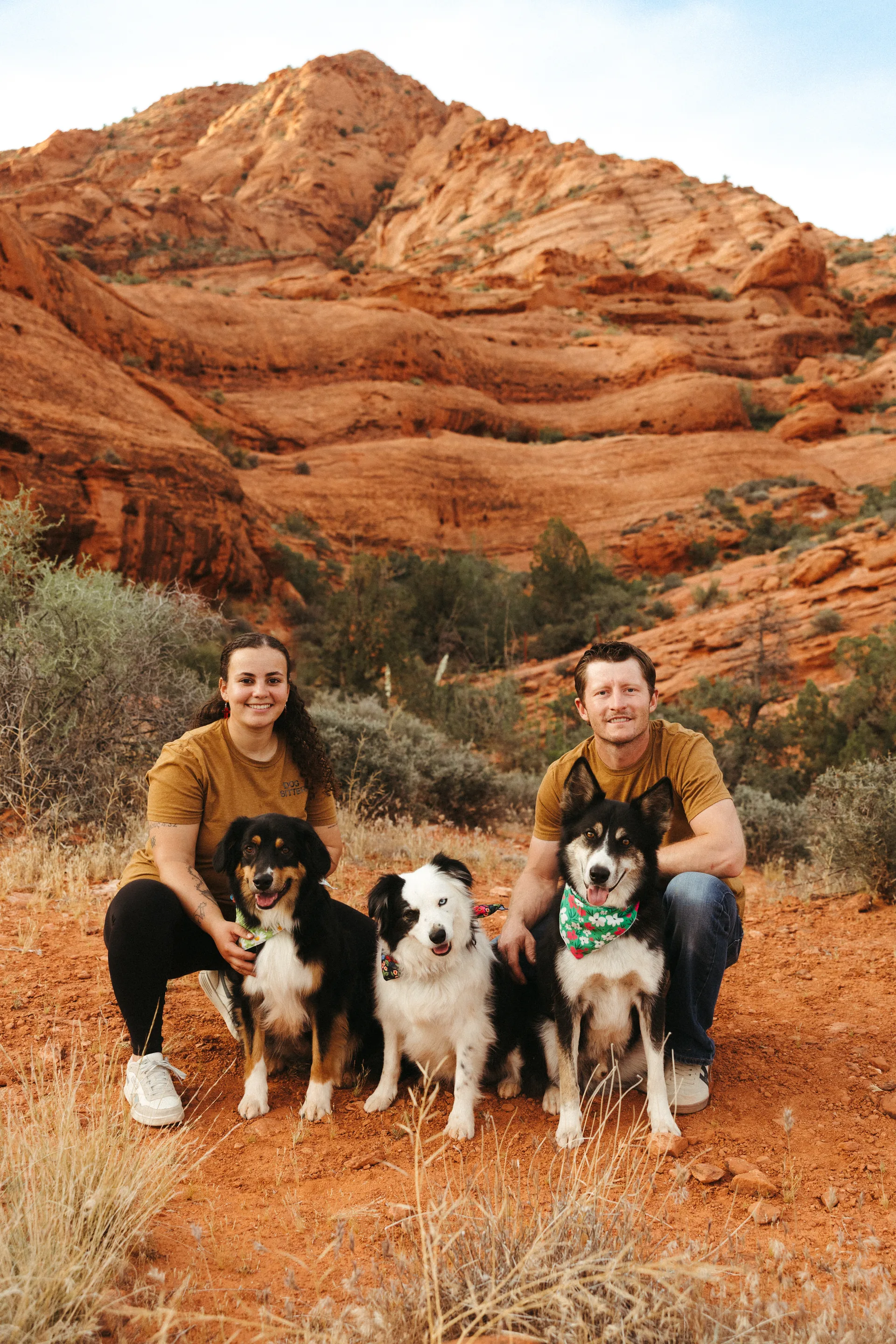 Couple with their dogs overlooking Utah red rock canyons